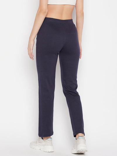 Navy blue solid mid-rise cotton trackpants with elastic waistband and drawstring closure.