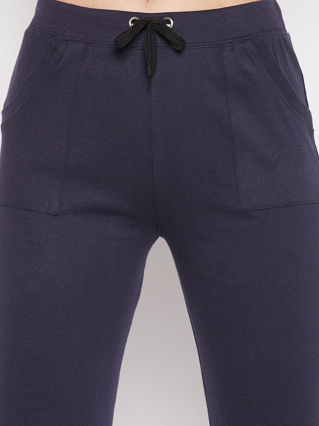 Navy blue solid mid rise cotton trackpants with elasticated waistband and drawstring closure.