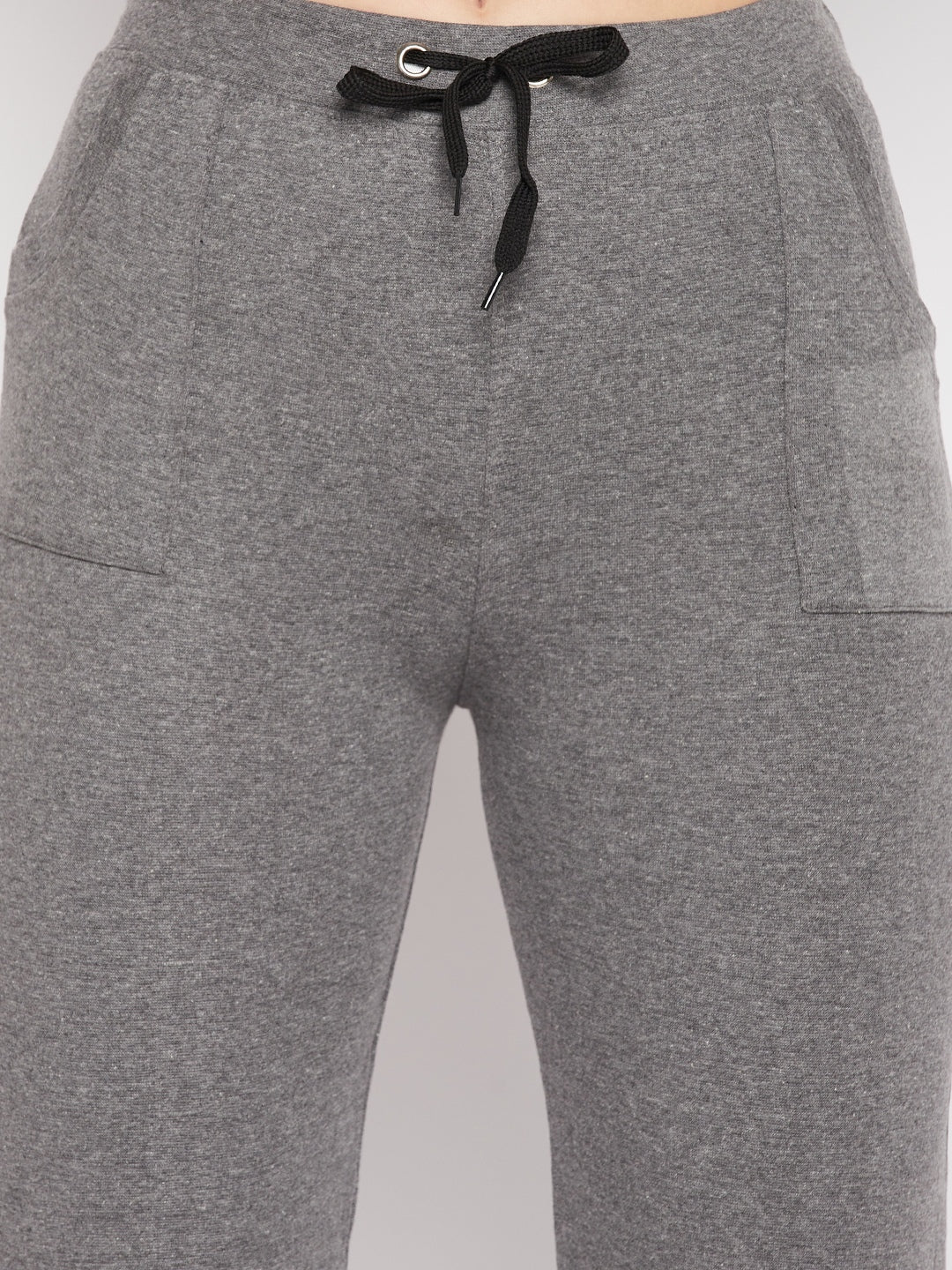 Light grey solid mid rise cotton trackpants with elasticated waistband and drawstring closure.