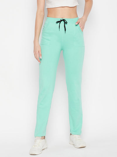 Sea green solid mid-rise cotton trackpants with elastic waistband and drawstring closure.