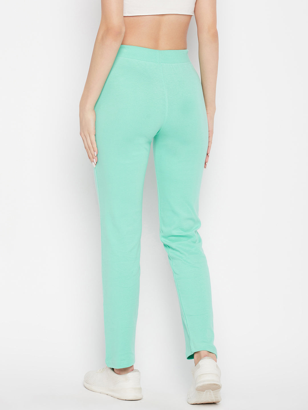Sea green solid cotton trackpants with elastic waistband and drawstring closure.