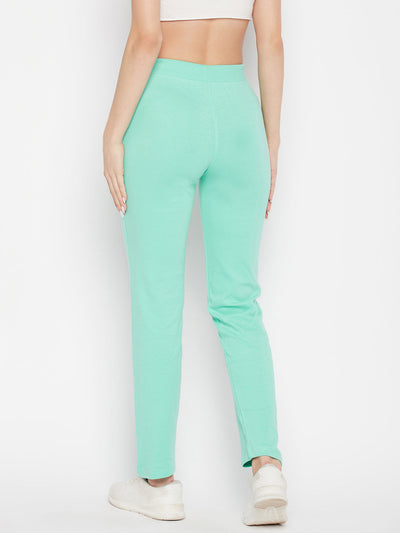 Sea green solid cotton trackpants with elastic waistband and drawstring closure.