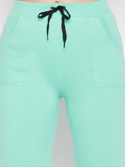Sea green mid-rise cotton trackpants with elasticated waistband and drawstring closure.