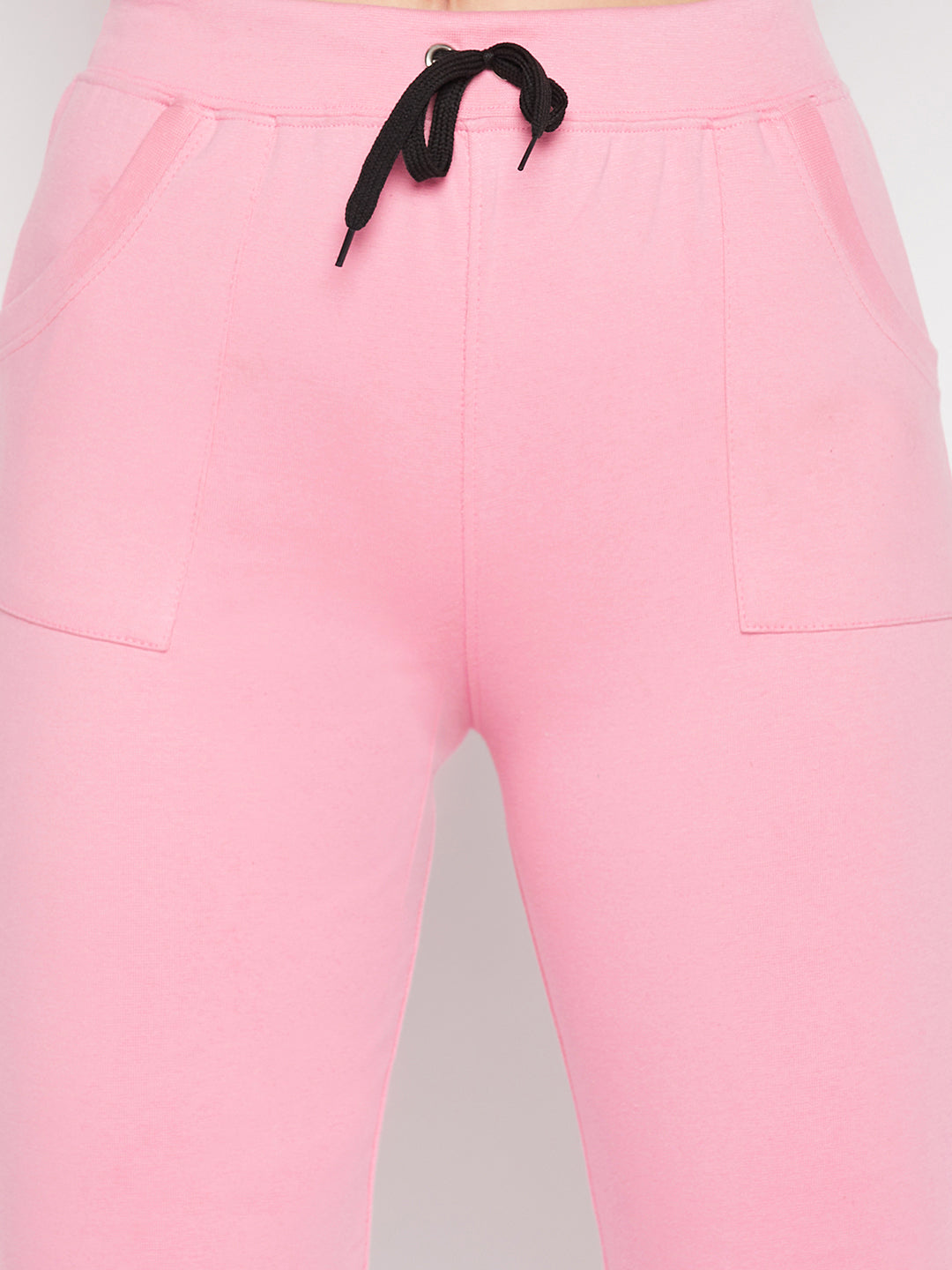 Baby pink solid mid-rise cotton trackpants with elastic waistband and drawstring.