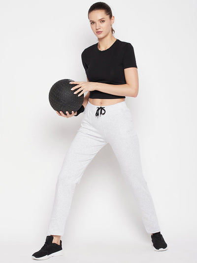 White solid mid rise cotton trackpants with elastic waistband and drawstring closure.