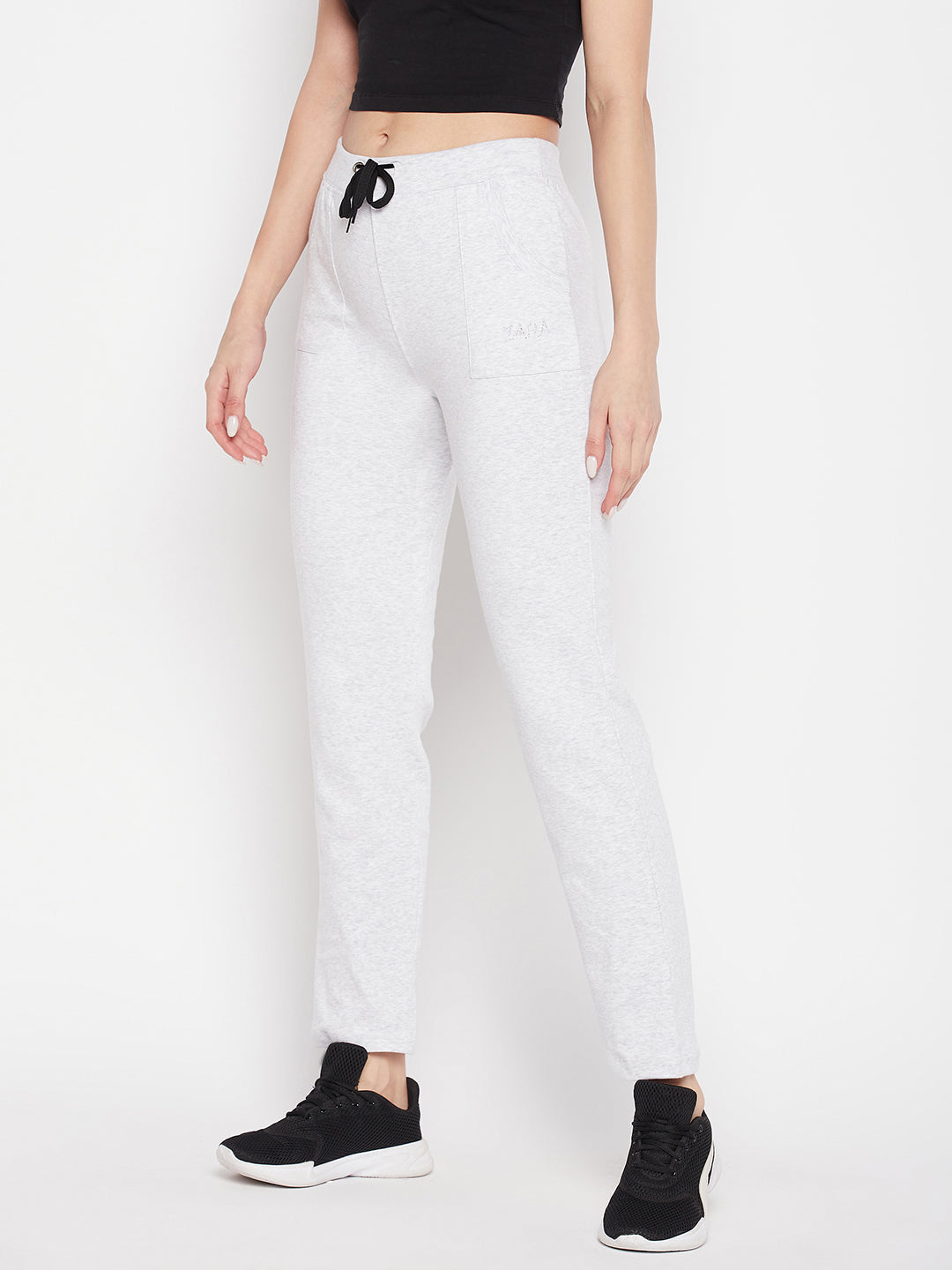 White solid mid rise cotton trackpants with elasticated waistband and drawstring closure.