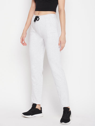 White solid mid rise cotton trackpants with elasticated waistband and drawstring closure.