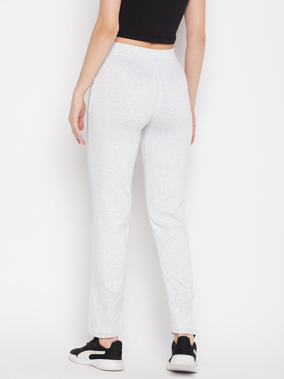 White solid mid rise cotton trackpants with elasticated waistband and drawstring closure.