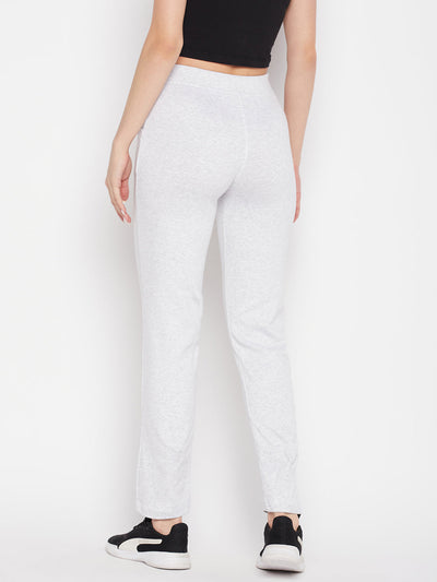 White solid mid rise cotton trackpants with elasticated waistband and drawstring closure.