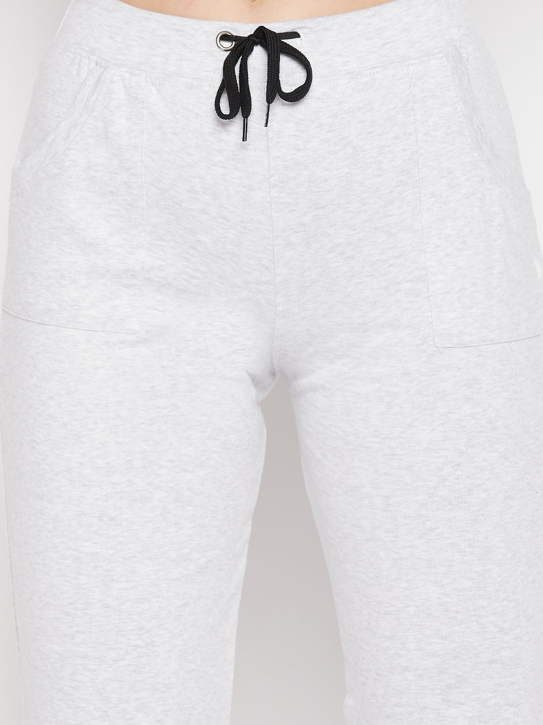 White solid mid rise cotton trackpants with elasticated waistband and drawstring.