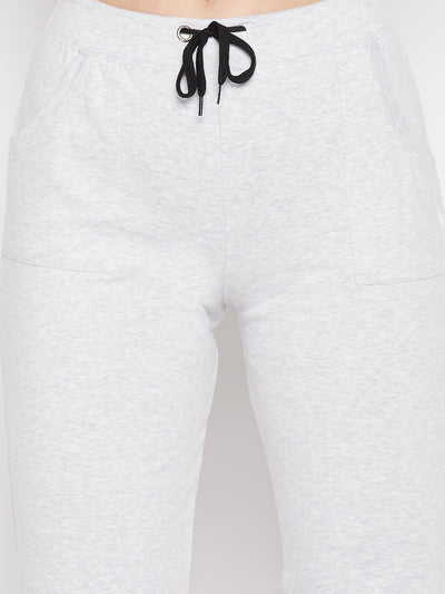 White solid mid rise cotton trackpants with elasticated waistband and drawstring.