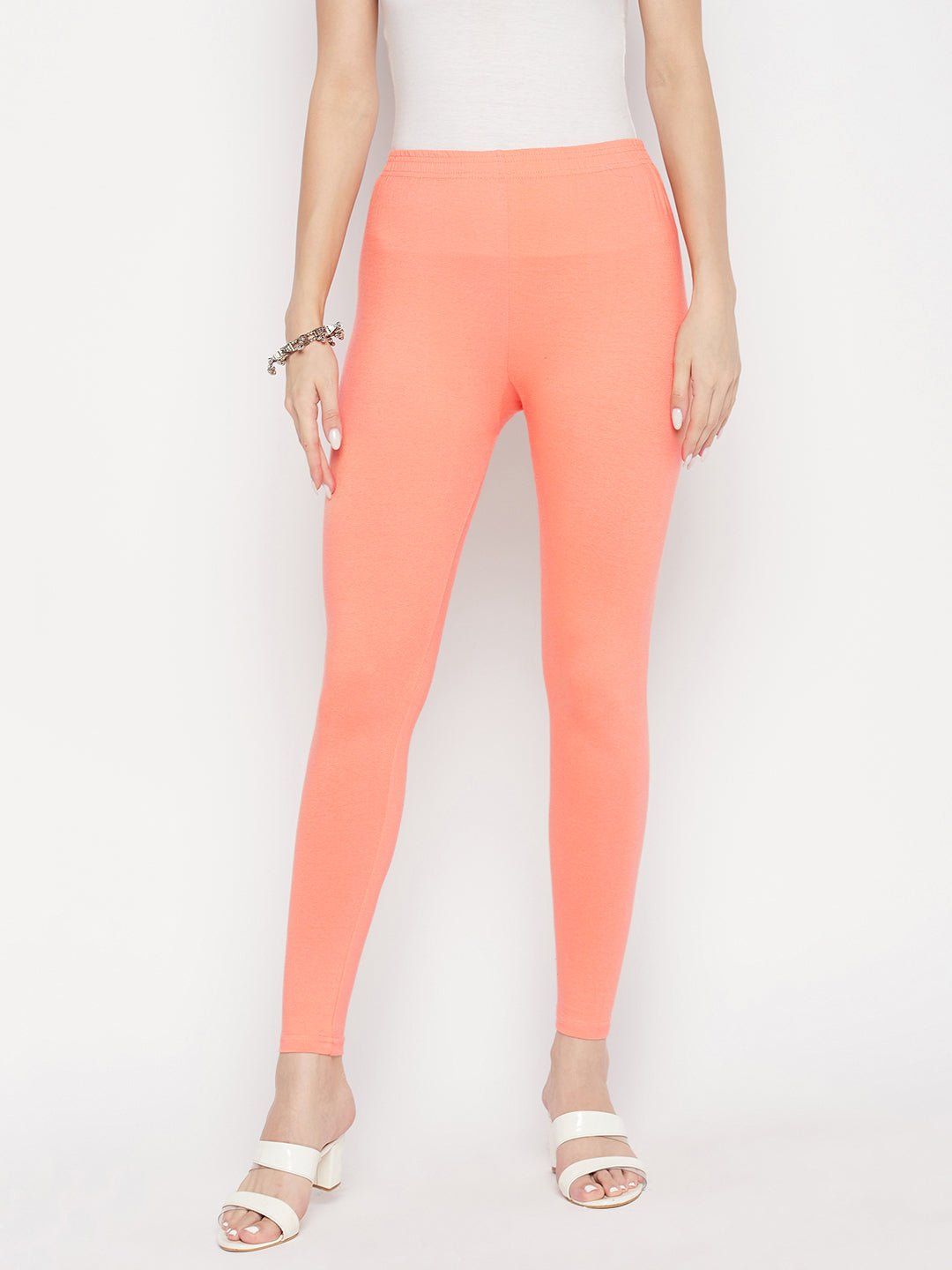 Peach solid ankle length leggings with elasticated waistband.