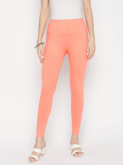 Peach solid ankle length leggings with elasticated waistband.