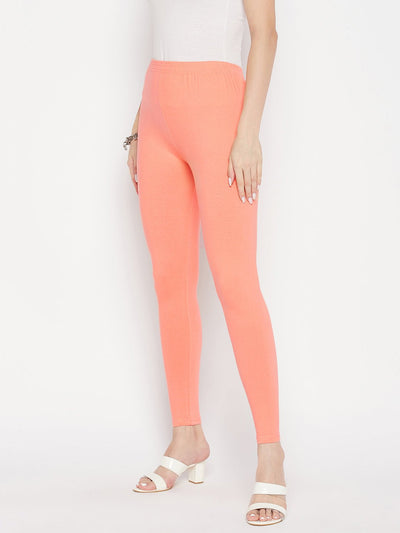 Peach solid ankle length leggings with elastic waistband.