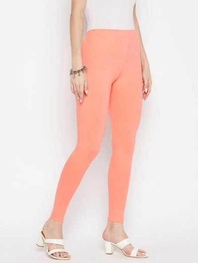 Peach solid ankle length leggings with elasticated waistband.