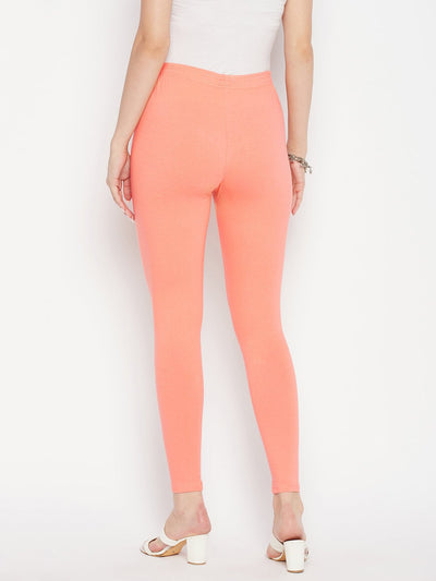 Peach solid ankle length leggings with elasticated waistband.