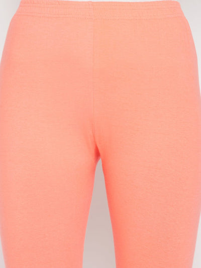 Peach solid ankle length leggings with elasticated waistband.