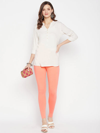 Peach solid ankle length leggings with elastic waistband.