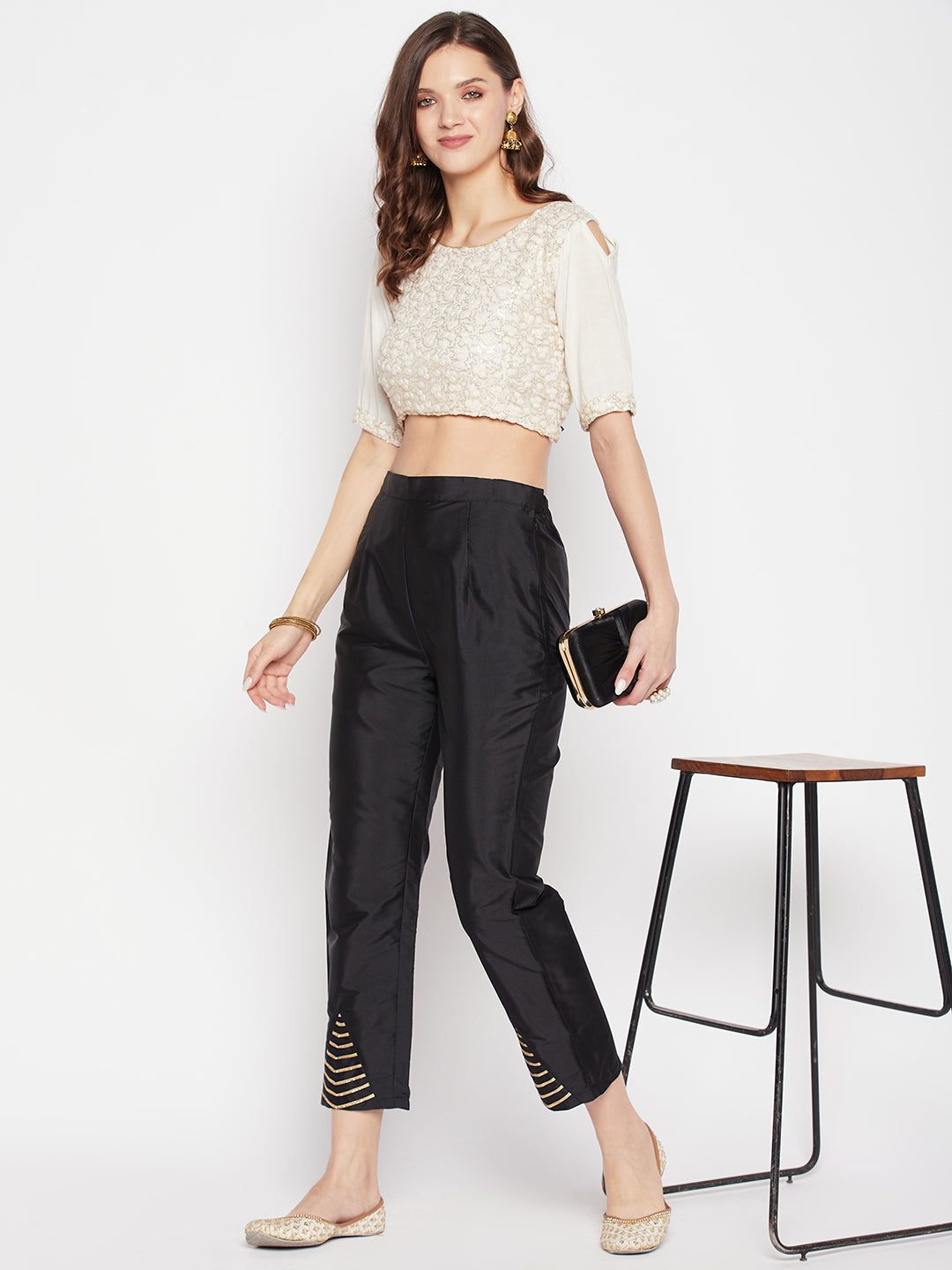 Black solid taffeta silk trouser with ankle length and partially elasticated waistband.