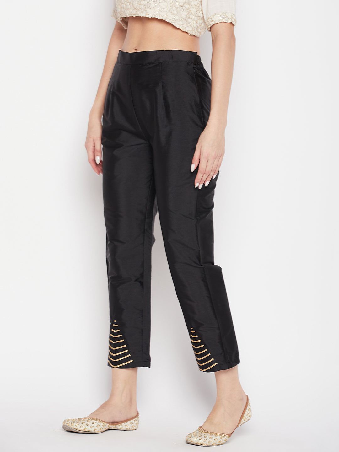 Black solid taffeta silk trousers, ankle length, partially elasticated waistband.