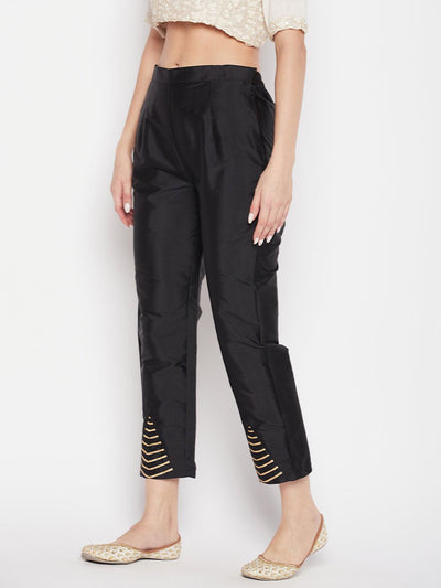 Black solid taffeta silk trousers, ankle length, partially elasticated waistband.
