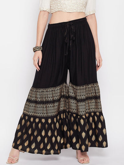 Black printed rayon flared gharara with elasticated waistband and drawstring.