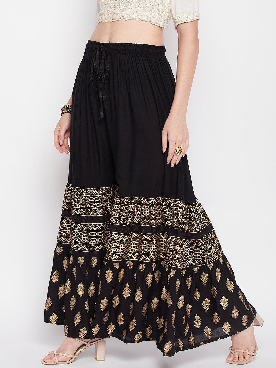 Black printed rayon flared gharara with elasticated waistband and drawstring.
