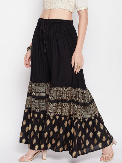 Black printed rayon flared gharara with elasticated waistband and drawstring.