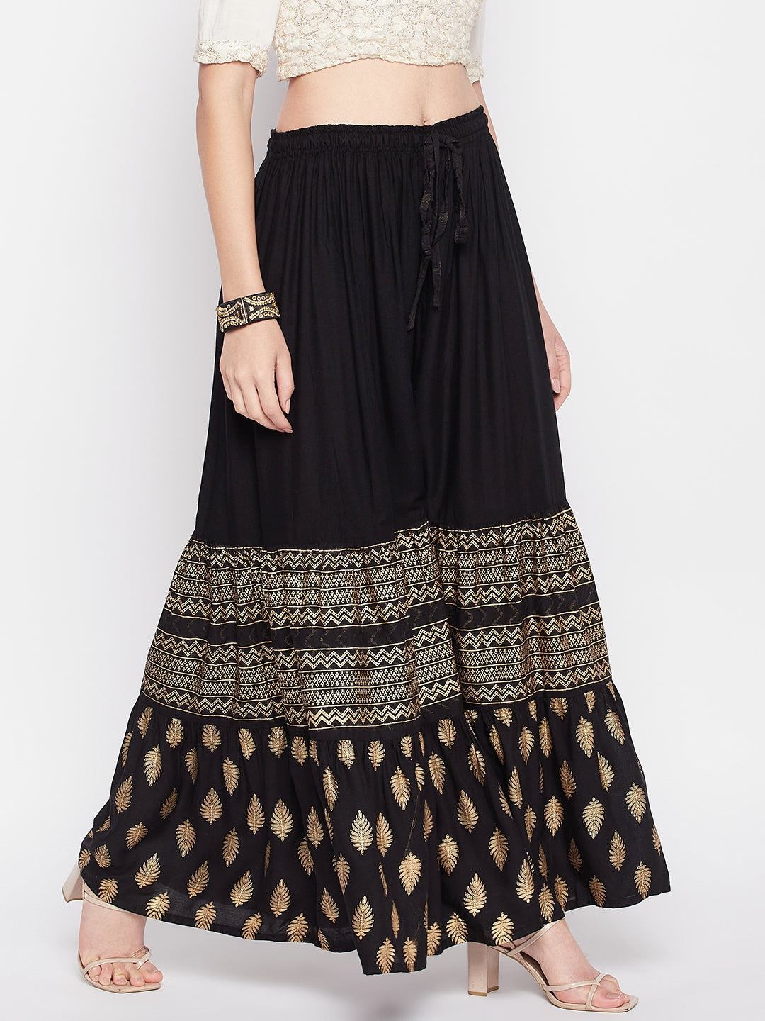 Black printed rayon flared gharara with elasticated waistband and drawstring.