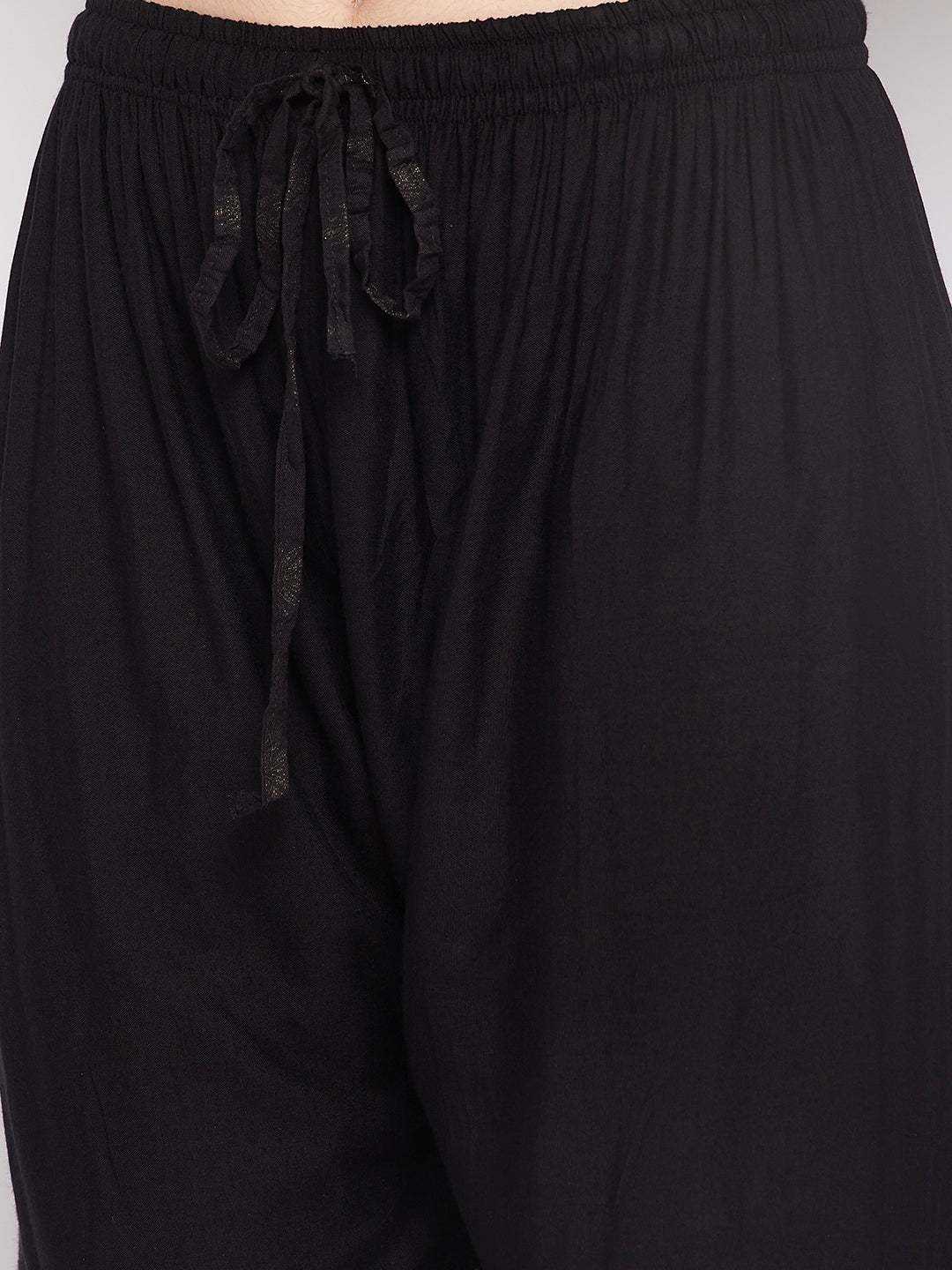 Black printed rayon flared gharara with elasticated waistband and drawstring.