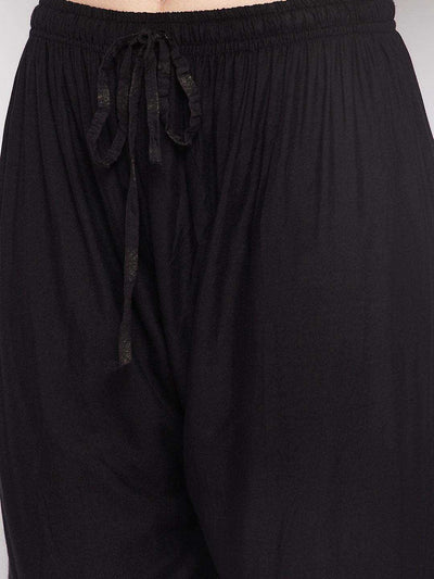 Black printed rayon flared gharara with elasticated waistband and drawstring.