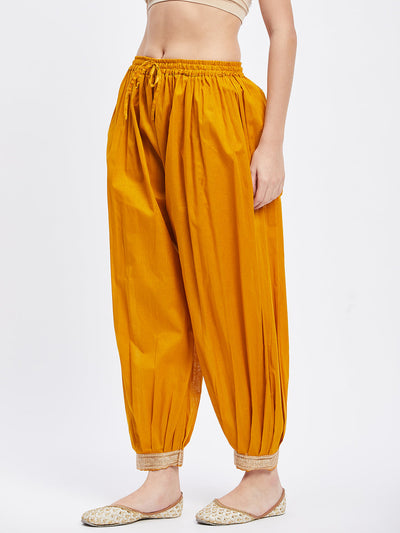 Mustard Embellished Afghani Salwar with elasticated waistband and hemline detailing.