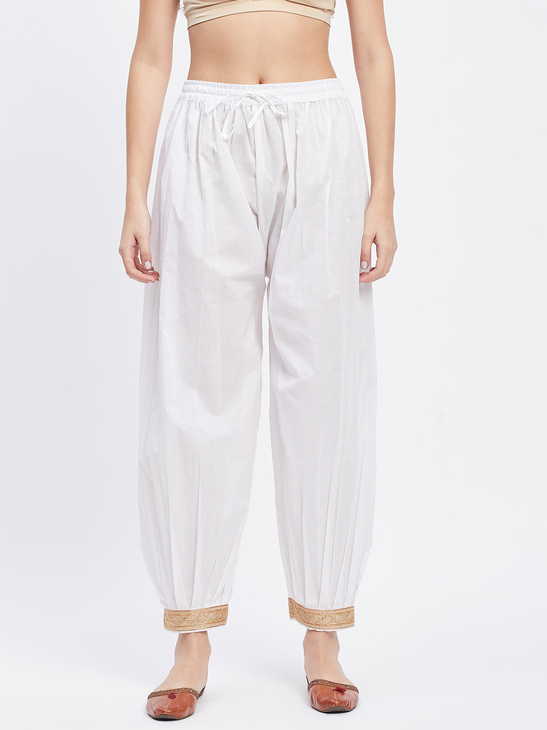 White Embellished Afghani Salwar with elastic waistband and decorative hemline.