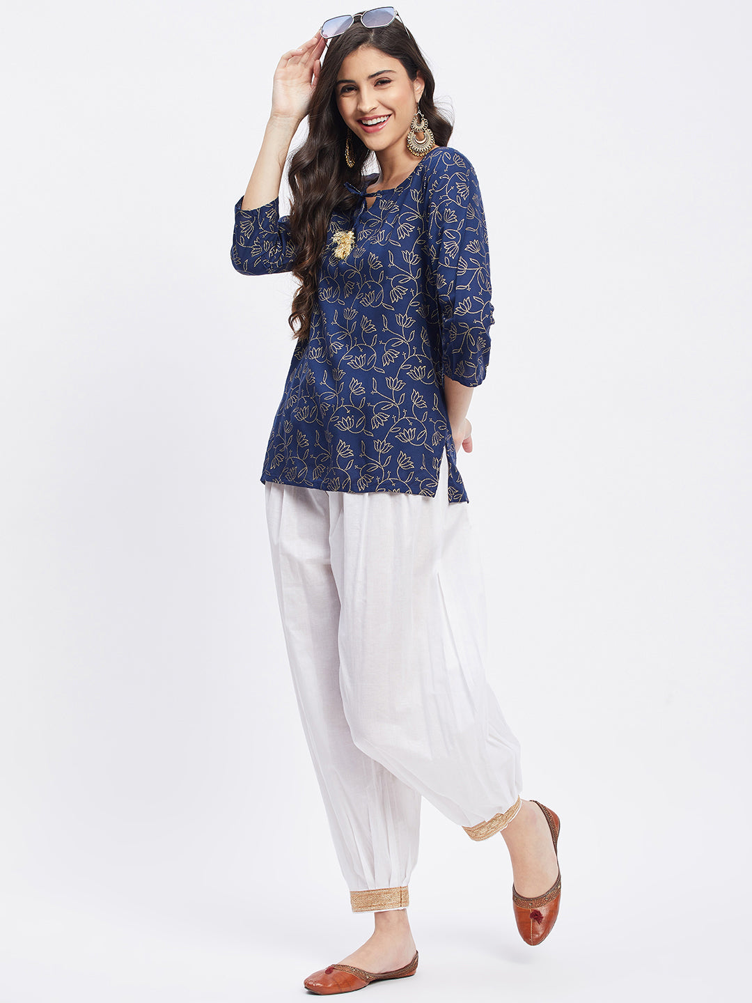 White embellished Afghani salwar with elasticated waistband and embellished hemline.