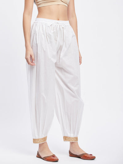 White embellished Afghani salwar with elasticated waistband and drawstring.