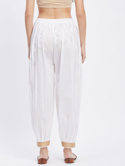 White embellished Afghani salwar with elasticated waistband and drawstring.