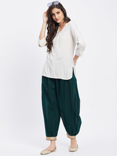 Bottle Green Embellished Afghani Salwar with elastic waistband and embellished hemline.