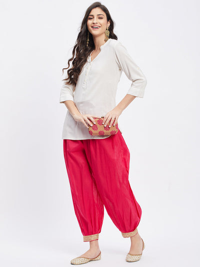 Magenta embellished Afghani salwar with elastic waistband and drawstring.