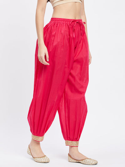 Magenta embellished Afghani salwar with elasticated waistband and drawstring.