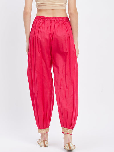 Magenta embellished Afghani salwar with elasticated waistband and drawstring.