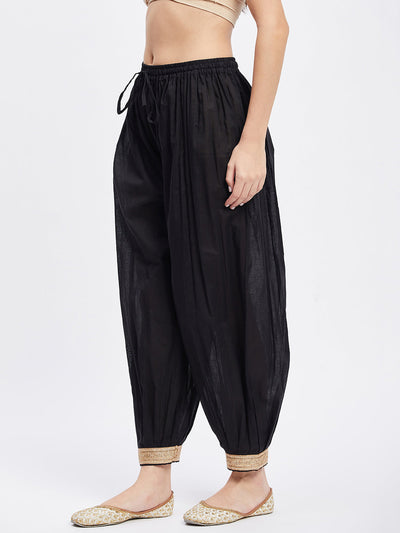 Black embellished Afghani salwar with elasticated waistband and drawstring.