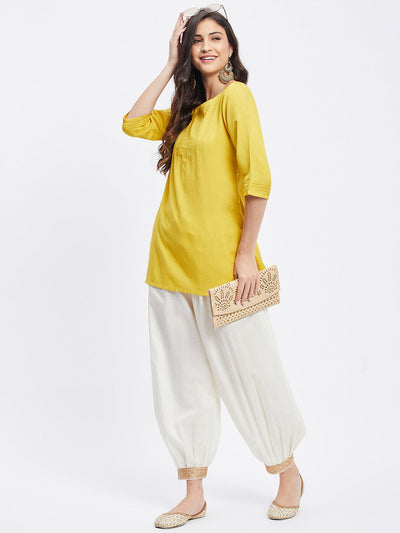 Cream Embellished Afghani Salwar with elastic waistband and decorative hemline.