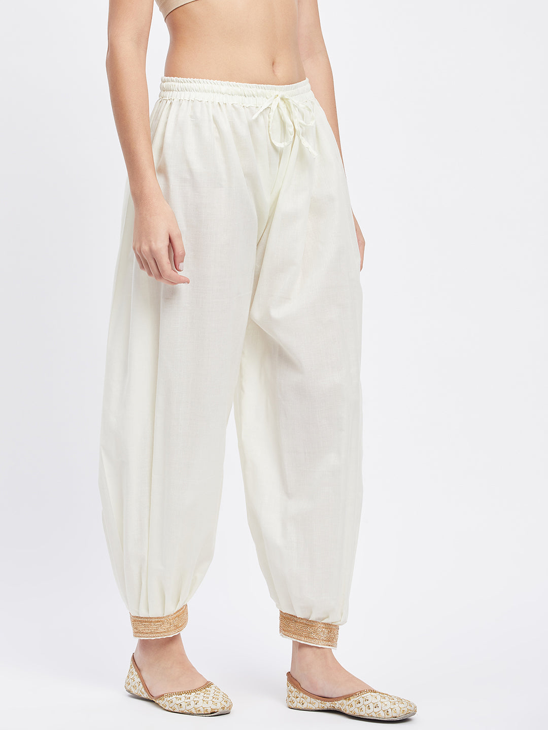 Cream embellished Afghani salwar with elasticated waistband and drawstring.