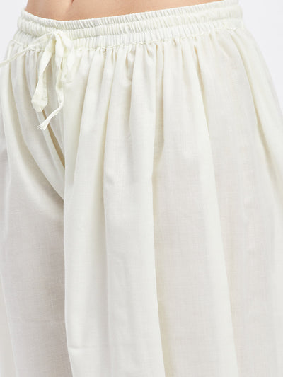 Cream embellished Afghani salwar with elasticated waistband and drawstring.