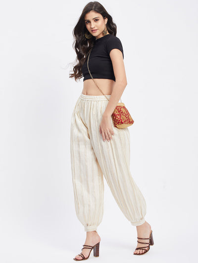 Off-White embellished golden Afghani salwar with elasticated waistband and embellished hemline.