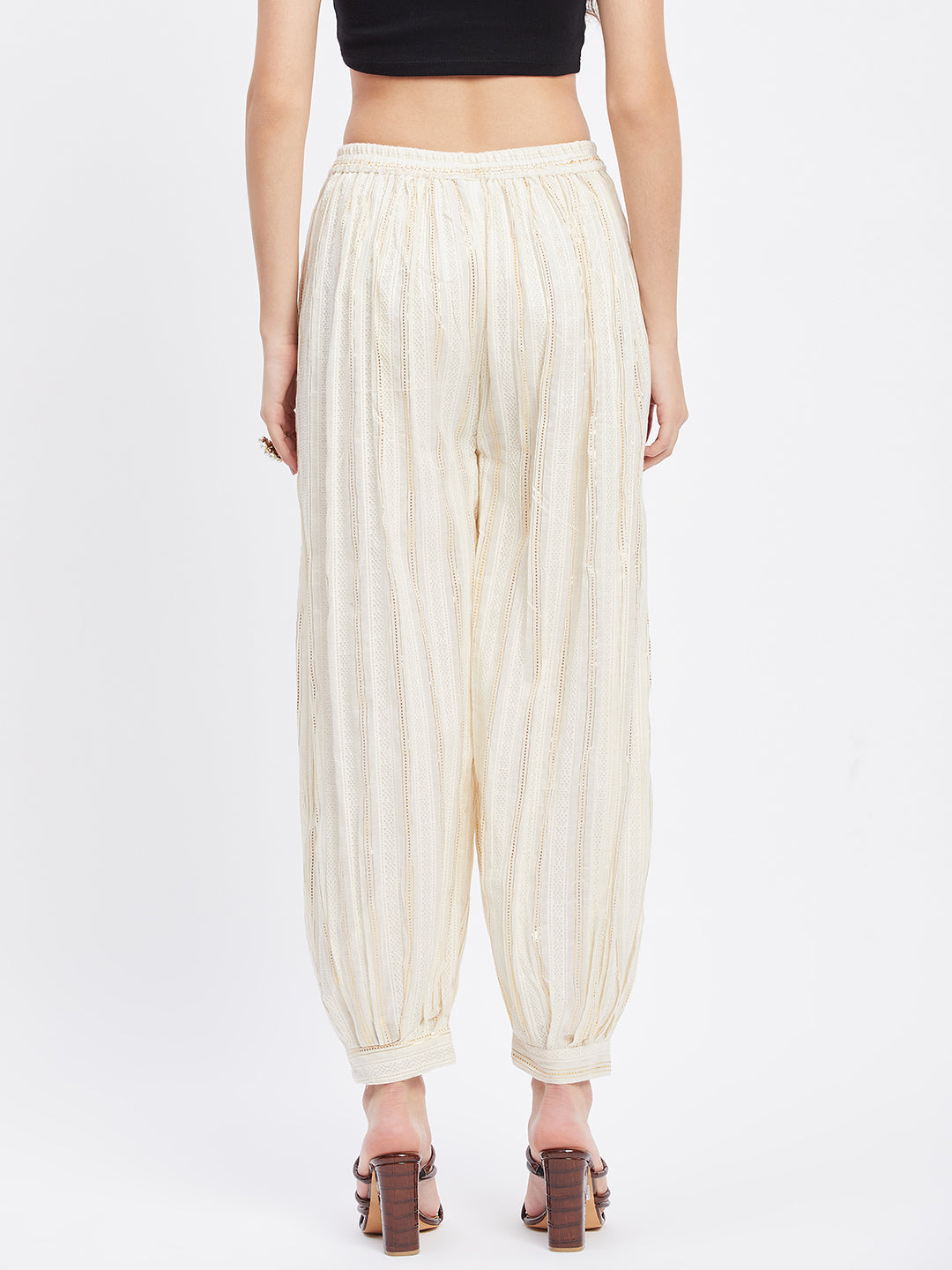 Off-white embellished golden Afghani salwar with self design and elasticated waistband.