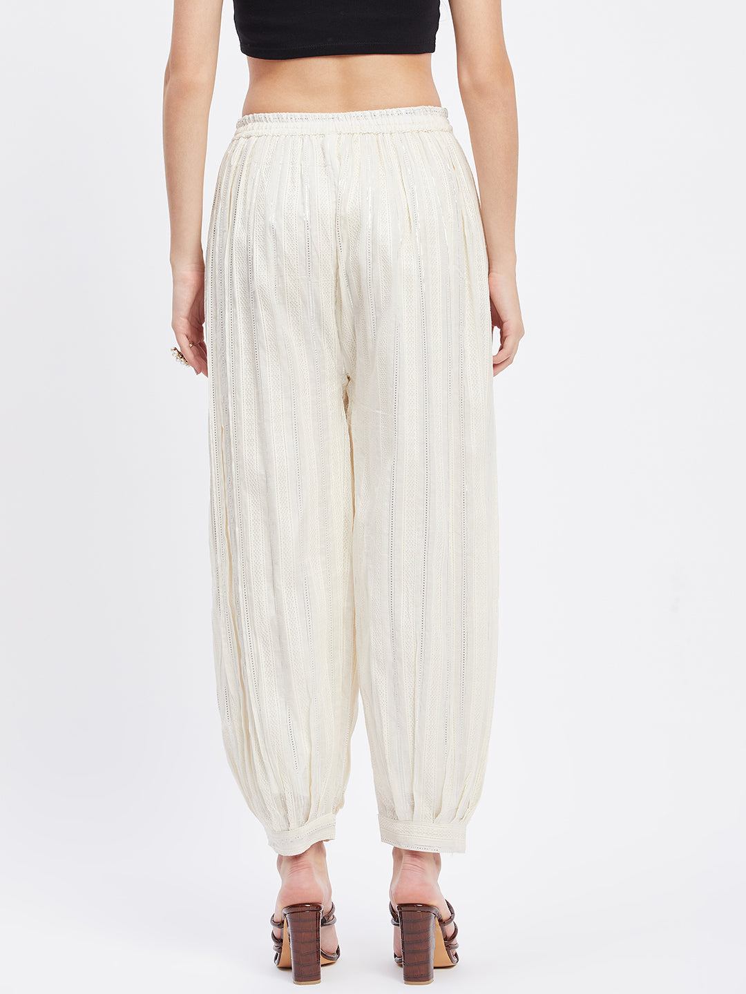 Off-white embellished silver Afghani salwar with elastic waistband and drawstring.