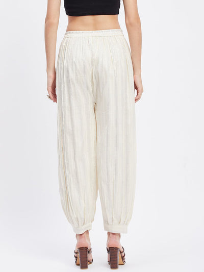 Off-white embellished silver Afghani salwar with elastic waistband and drawstring.