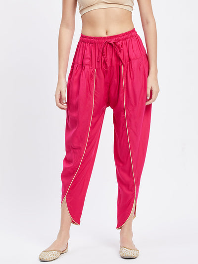 Magenta solid rayon tulip pant with elasticated waistband and drawstring.
