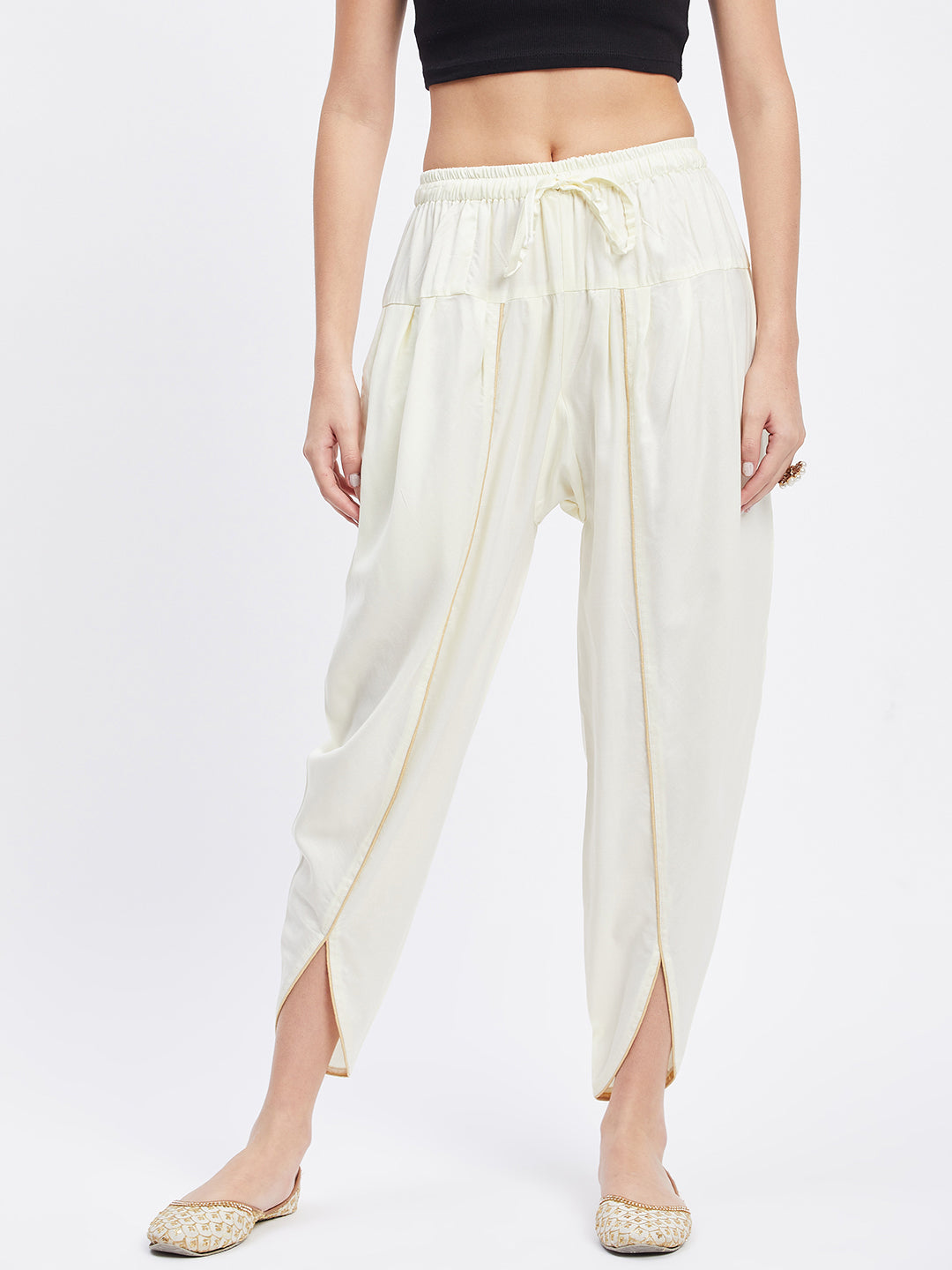 Cream solid rayon tulip pant with elastic waistband and side pocket.